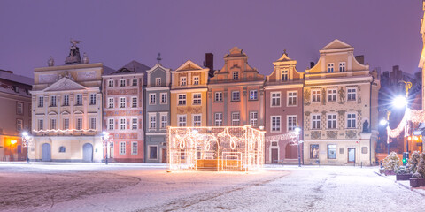Fototapeta na wymiar Panoramic view with merchants houses and decorated fountain at Old Market Square in Old Town at Christmas night, Poznan, Poland