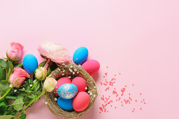 Fototapeta na wymiar Composition with beautiful Easter eggs and flowers on color background