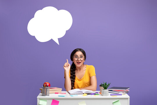 Smiling indian woman pointing up at speech bubble