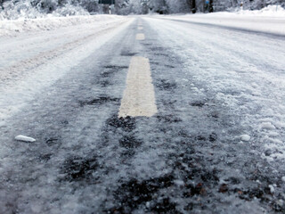 De-icing chemicals and sand on the winter road.Winter road