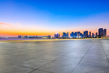 Obraz premium Empty square floor and modern city skyline in Hangzhou at sunrise,China.