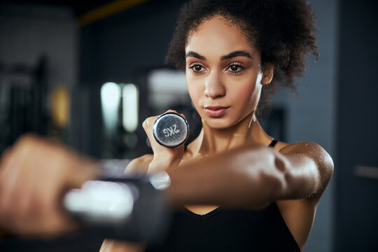 Portrait of pretty female doing sport in the gym