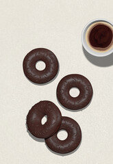 3d render fashion flat lay scene..Chocolate totally donuts and coffee cup on white textured background. Minimalistic breakfast creative food style concept