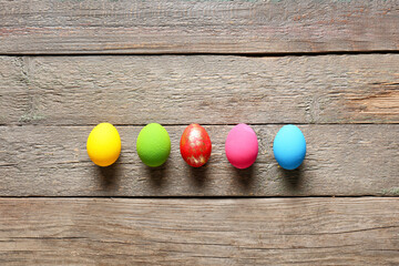 Beautiful Easter eggs on wooden background