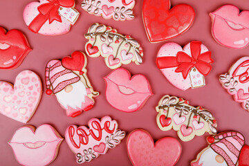 Closeup of variation of different cookies for valentine's day. Heart, love and kiss cookie on pink background. Present gift or background for Valentine or Mother's day. Lovely sweet gift or postcard