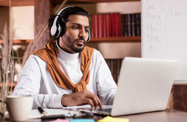 Man Having Virtual Lesson Via Video Call On Laptop Indoor