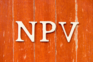 Alphabet letter in word NPV (Abbreviation of net present value) on old red color wood plate background