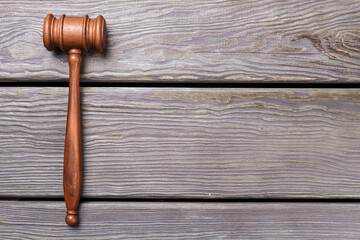 Judge gavel on the desk. Grey table and copy space.