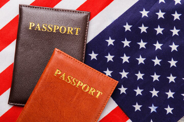 Fototapeta na wymiar Passports on the usa flag. Top view passport covers.