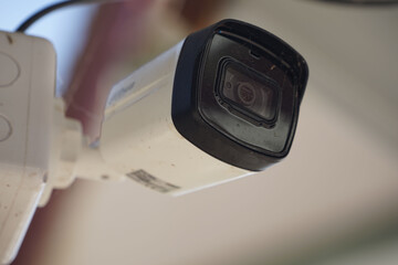Dirty CCTV cameras are installed on the eaves for detecting property theft. CCTV security camera outdoors.