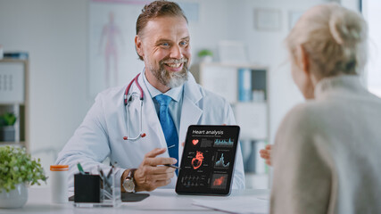 Doctor Consultation Office: Female Patient Listens to Experienced Cardiologist Uses Digital Tablet Computer to Show, Explain Heart Analysis Results, Give Advice, Prescribe High-Pressure Medicine