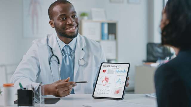 Doctor Consultation Office: Female Patient Listens to Experienced Cardiologist Uses Digital Tablet Computer to Show, Explain Heart Analysis Results, Give Advice, Prescribe High-Pressure Medicine