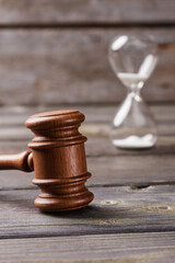 Close-up wooden gavel and houglass. Law and justice concept.