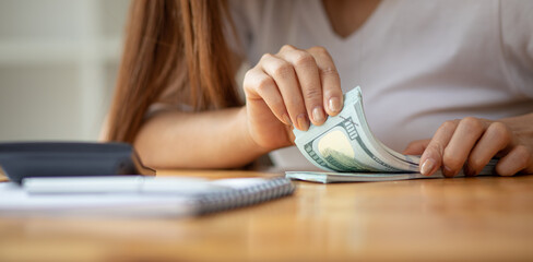 Businesswoman hands counting us dollar banknotes
