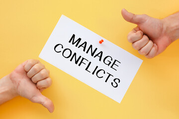 Male hands show signs of approval or disapproval. Postcard with the inscription MANAGE CONFLICTS