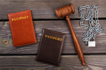Top view passports gavel and chains. Immigration problem concept.