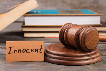 Innocent verdict concept. Gavel and stack of law books.
