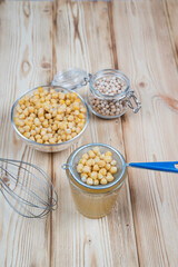 On a wooden table, a decoction of Aquafaba chickpeas. The use of vegetable protein in the preparation of vegan dishes