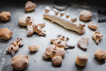 Kids activity with bread dough, baked snowman and other figures 
