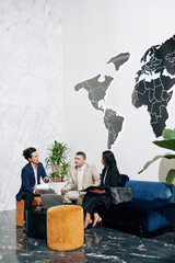 Serious entrepreneur explaining details in report to business partners at meeting in modern office