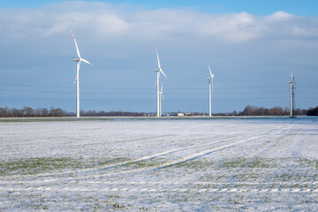 Fototapeta na wymiar Wind farm for electric power production. Winter landscape in northern Poland. Europe