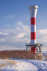 New lighthouse on the banks of the Elbe in Hamburg in winter .Vertical image