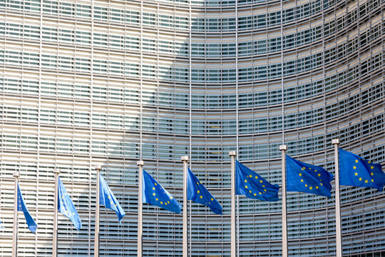 Brussels, Belgium - April 18, 2019: A row of flags of the European Union is flying in the wind in front of the Berlaymont building, seat of the European Commission.