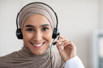 Closeup portrait of cheerful female doctor with headset