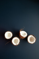 Coconuts lying on dark blue background