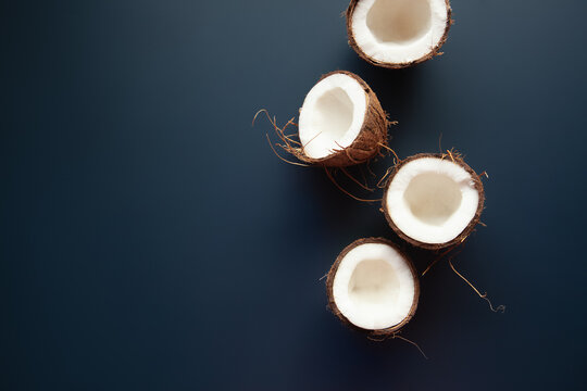 Coconuts lying on dark blue background