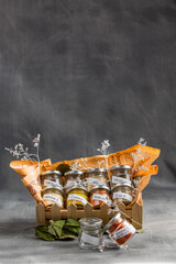 basket with small jars with condiments