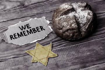 bread, star of david and the inscription we remember on a wooden table