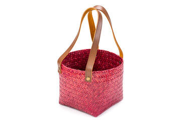 Red wicker basket with leather handle solated on white background, concept of no more plastic shopping bags.