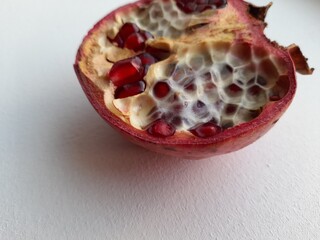 Half pomegranate on a white background, top view.