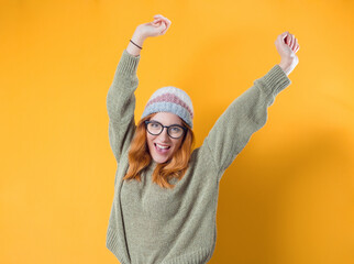 Cheerful smiling young woman with arms raised, isolated on white background