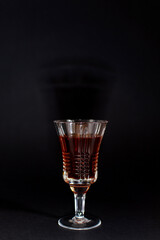 A glass of alcohol on a black background