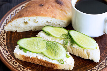 Breakfast. Sandwich with cream cheese and cucumber and black coffee. Traditional breakfast. Healthy...