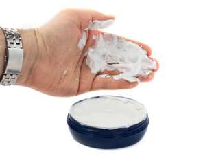the man takes with his palm a white hand cream from a blue jar. beauty concept, dry skin, skin hydration. White background.