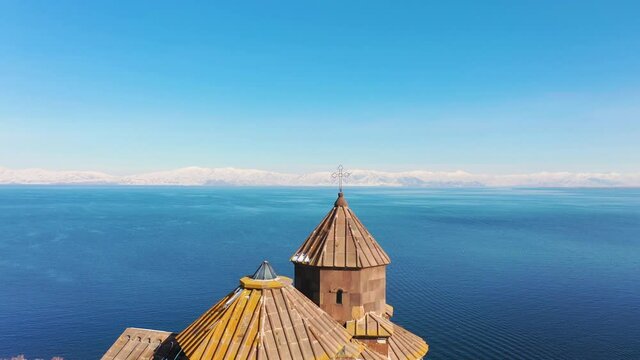 Church on the lake. Aerial view old, antique church on water background. 
Dome of the ancient, Christian monastery near the lake of Sevan. It was built in 9-12 centuries. 