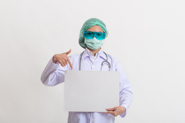 Female doctor in medical uniform and mask holding blank white banner