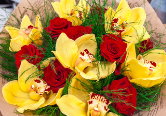 Bouquet of red roses and yellow orchids