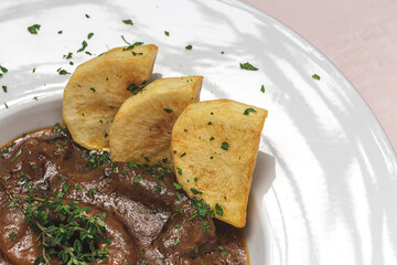 Homemade stew of osso buco meat with aromatic herb sauce