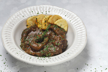 Homemade stew of osso buco meat with aromatic herb sauce