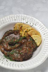 Homemade stew of osso buco meat with aromatic herb sauce