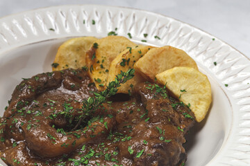 Homemade stew of osso buco meat with aromatic herb sauce