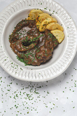 Homemade stew of osso buco meat with aromatic herb sauce