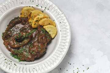 Homemade stew of osso buco meat with aromatic herb sauce