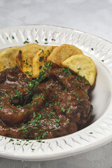 Homemade stew of osso buco meat with aromatic herb sauce