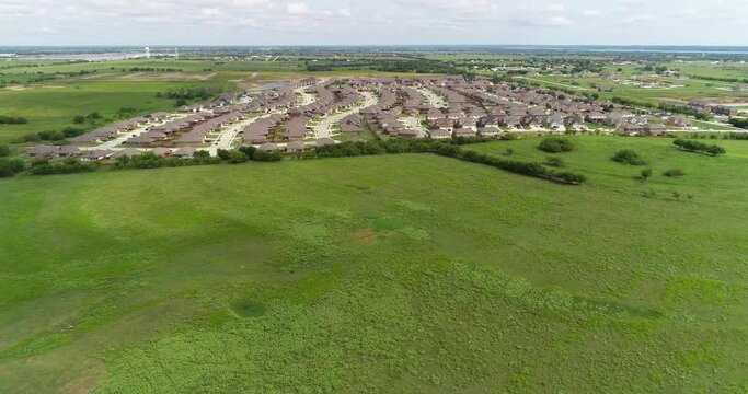 Aerial flight over the city of Sanger in Texas.  A neighborhood of houses can be seen.