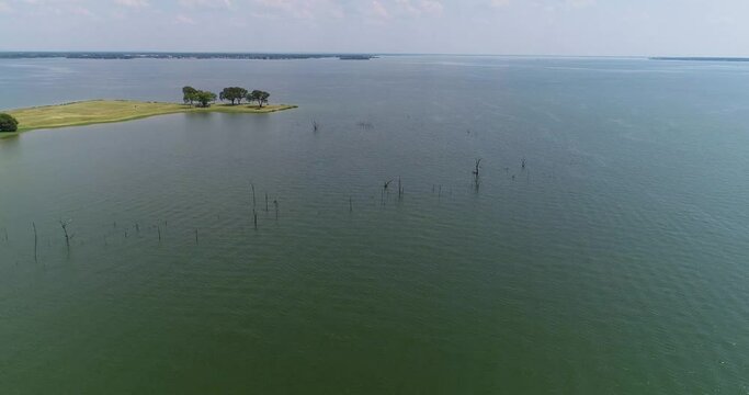 Aerial flight over Richland Chambers Lake.  Tree stumps around a peninsula are visible.